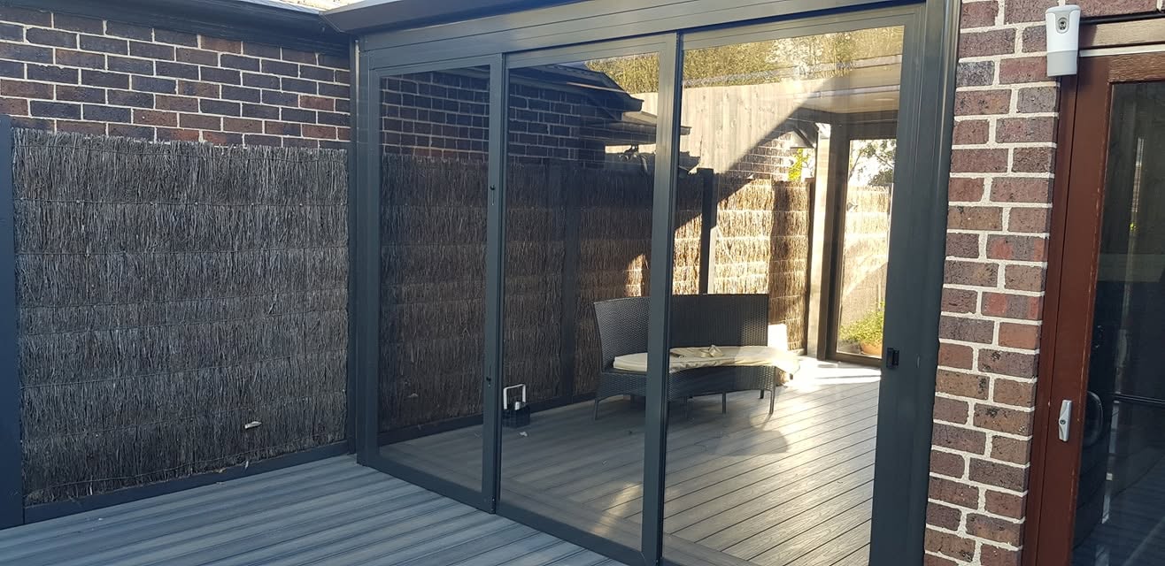 Charcoal weather screens enclosing a private timber deck