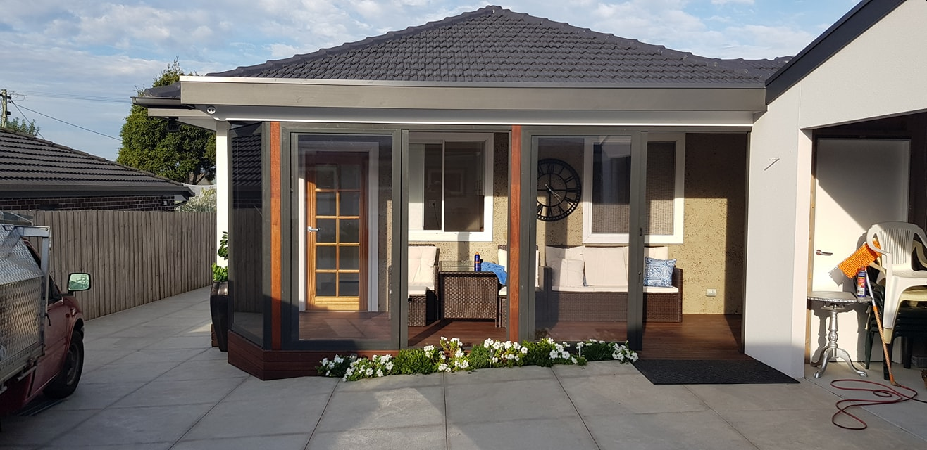 Charcoal weather screens enclosing a backyard deck